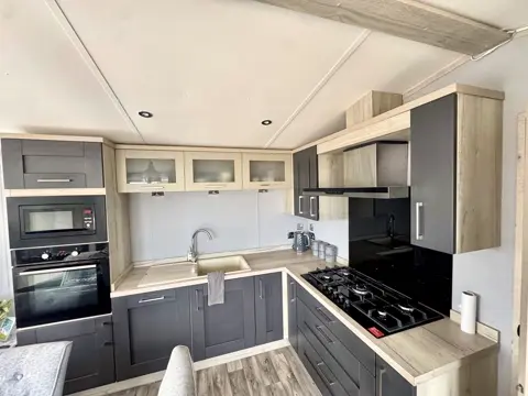 Well-equipped kitchen at Tŷ'r Môr with sink, gas hob and generous worktop space