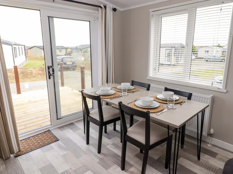 Enclosed front decking with outdoor furniture at Awel y Môr (Dolphin), near Little Haven