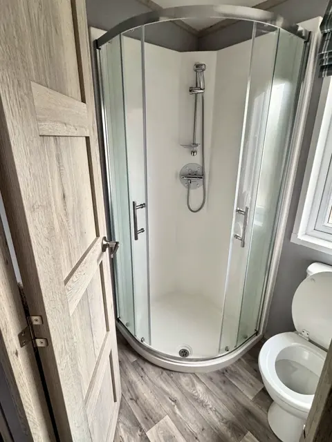 Shower room at Tŷ'r Môr with quadrant walk-in shower and WC