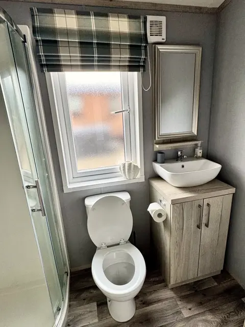 Jack-and-Jill shower room at Tŷ'r Môr with basin, vanity unit and WC