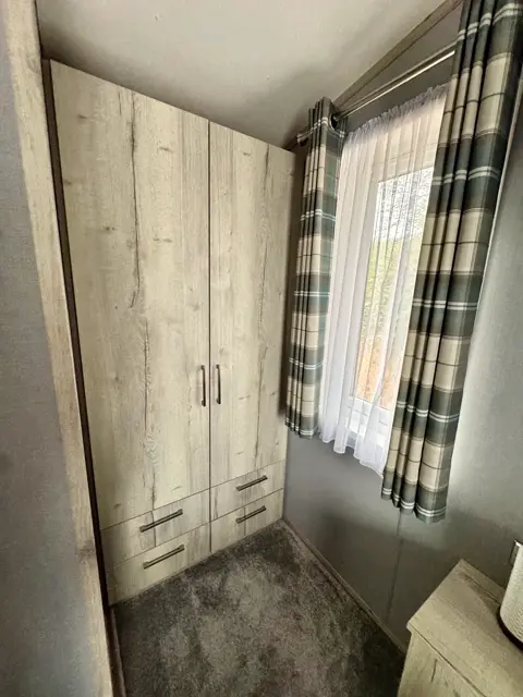 Fitted wardrobe and drawer storage in the main bedroom at Tŷ'r Môr